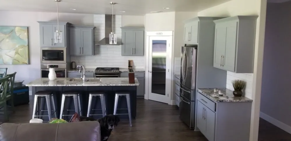 Kitchen with repainted gray cabinets and fresh wall paint by Travis Sheets Painting, Medford, Oregon